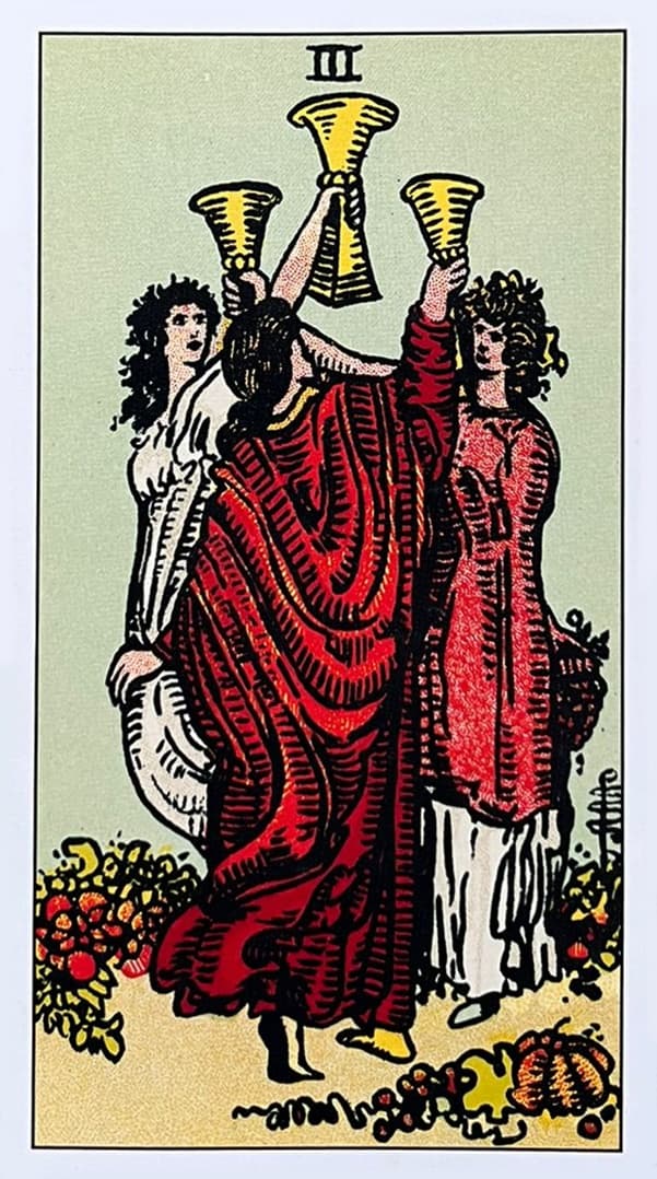 tr�s mulheres, cada uma segurando uma ta�a, brindando entre si em um gesto de celebra��o e comunh�o. As mulheres est�o em p� e parecem dan�ar em um c�rculo, o que refor�a o tema de conex�o e alegria coletiva. Elas est�o vestidas com vestes longas e fluidas que sugerem movimento e leveza, cada uma em cores diferentes, simbolizando a diversidade e a individualidade dentro da unidade.