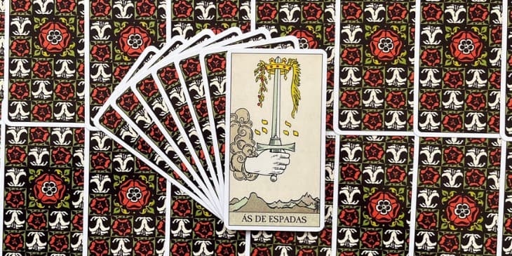uma m�o emergindo de uma nuvem, segurando uma espada apontada para o c�u. A espada em si � uma imagem potente de clareza e corte atrav�s da confus�o. A l�mina � n�tida e duplamente afiada, sugerindo que ela pode tanto criar quanto destruir, dependendo da inten��o por tr�s de seu uso. No topo da espada, uma coroa dourada entrela�ada com uma guirlanda de louros simboliza o sucesso e o triunfo da intelig�ncia sobre a adversidade.